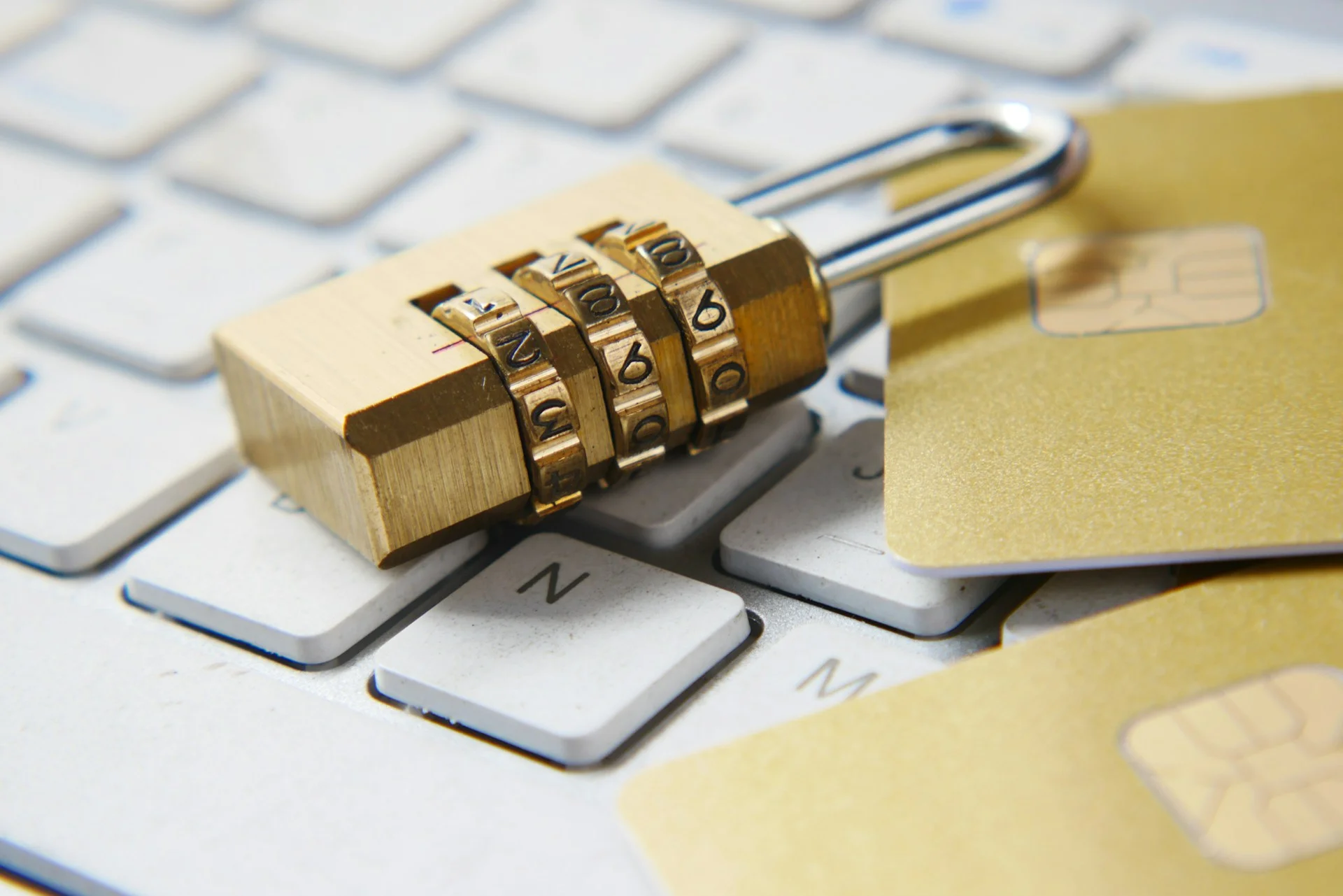 a golden padlock sitting on top of a keyboard a golden padlock sitting on top of a keyboard